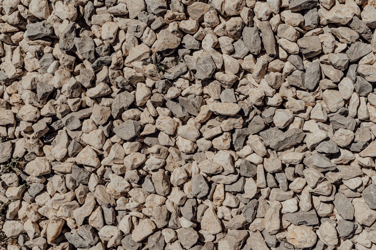 A compacted aggregate base being prepared for turf