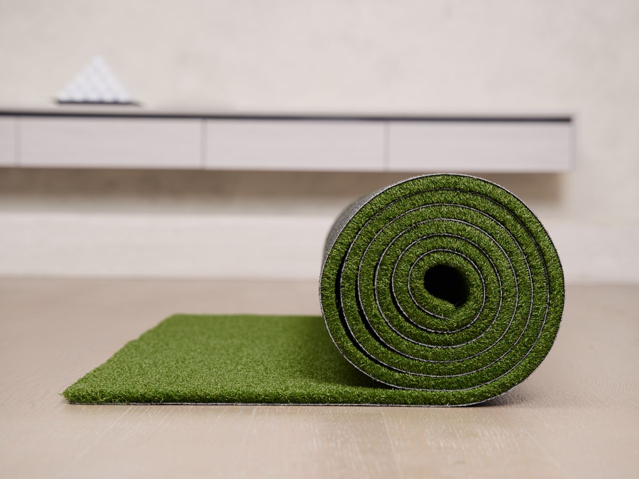 A rolled-up strip of artificial turf