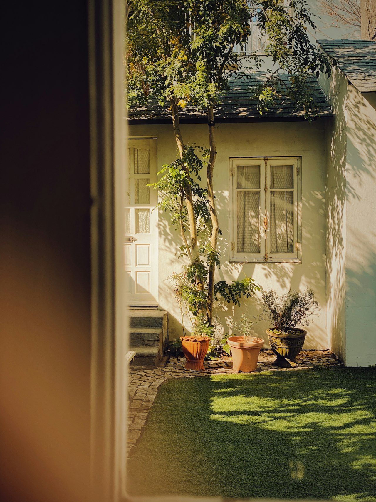 A small house with a green front yard