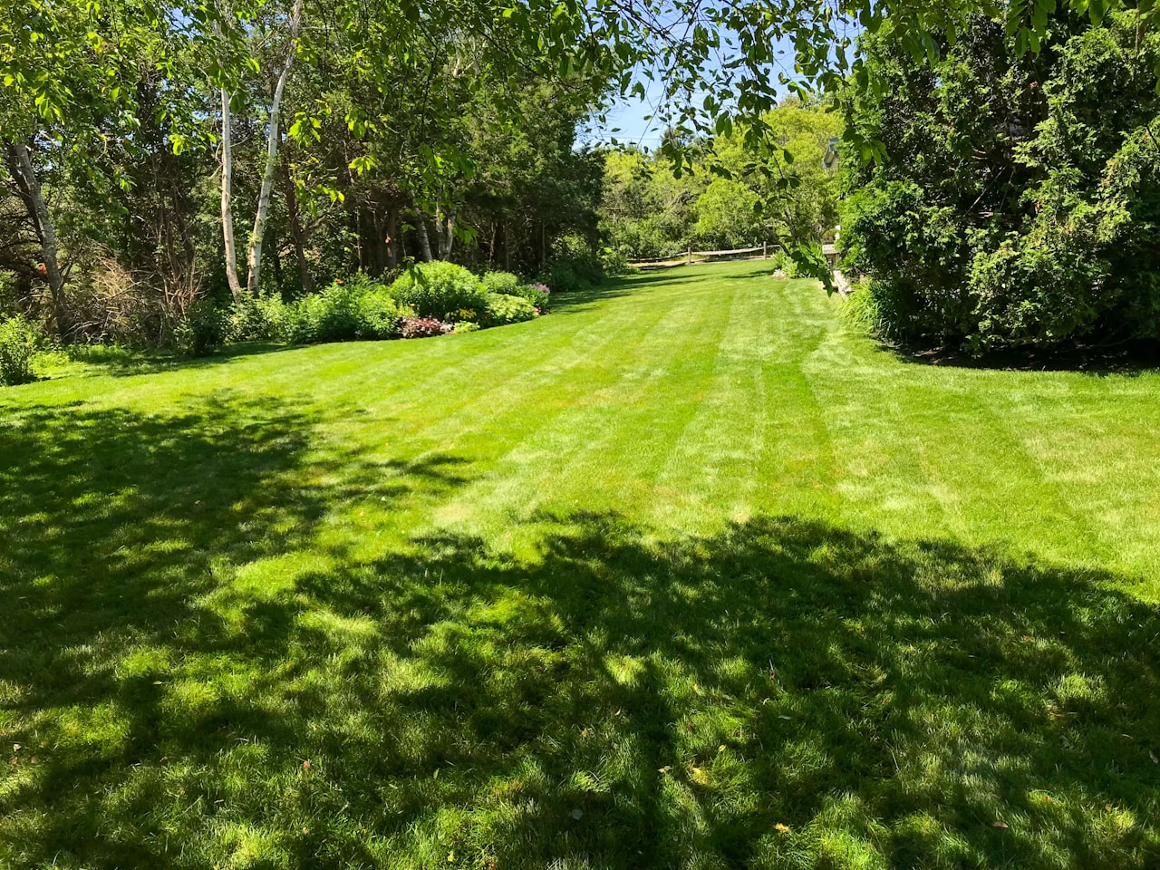A neatly installed artificial-grass lawn beside a home